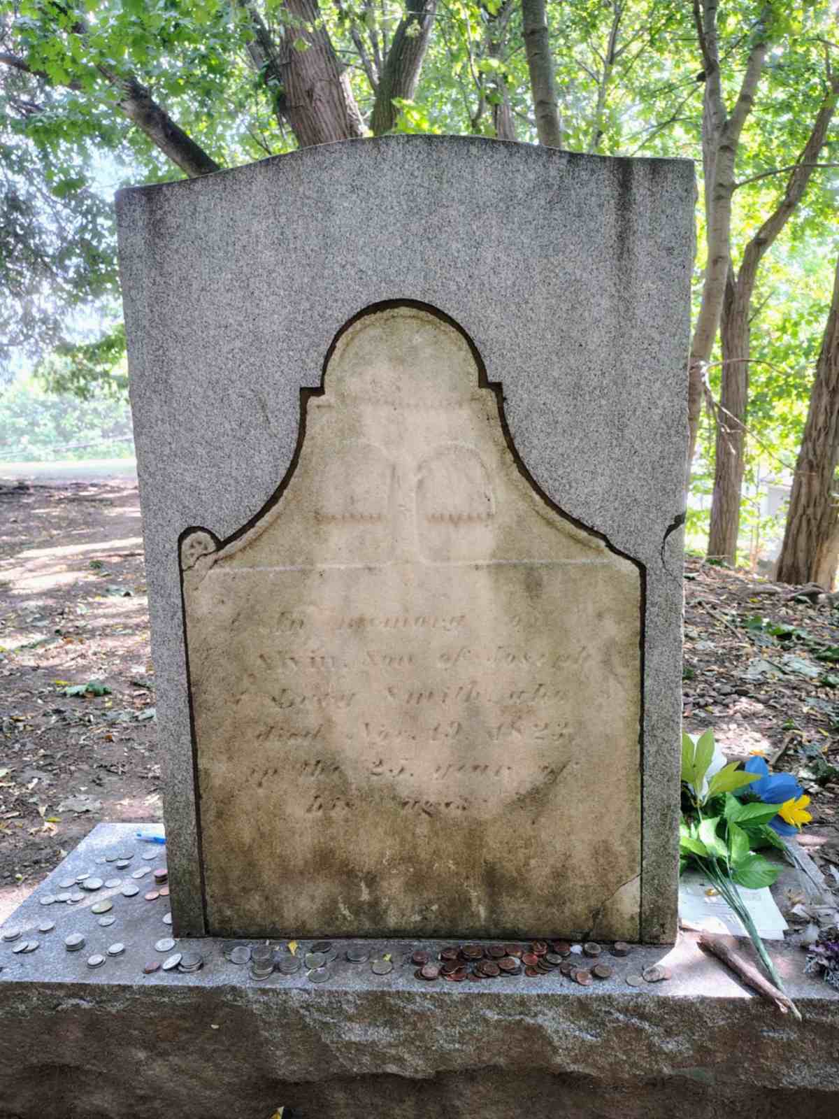 Front and back of Alvin Smith’s preserved grave marker, showing both the modern inscription and the original headstone.