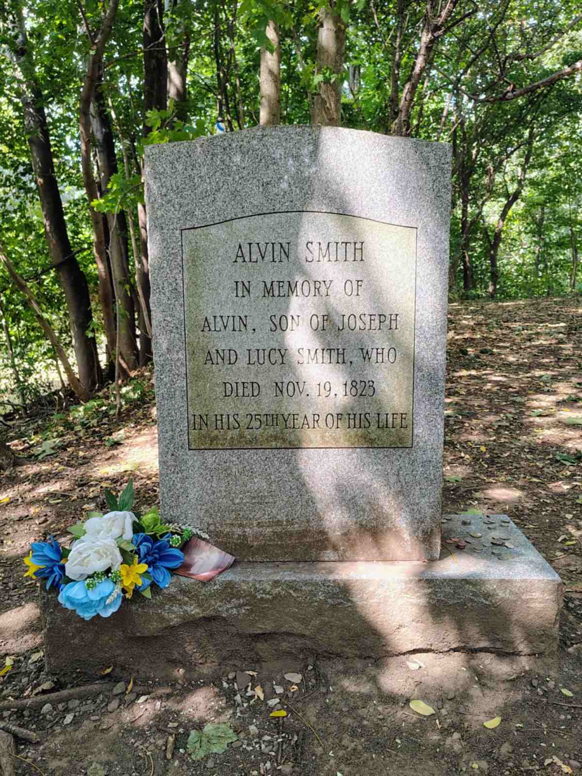 Front and back of Alvin Smith’s preserved grave marker, showing both the modern inscription and the original headstone.